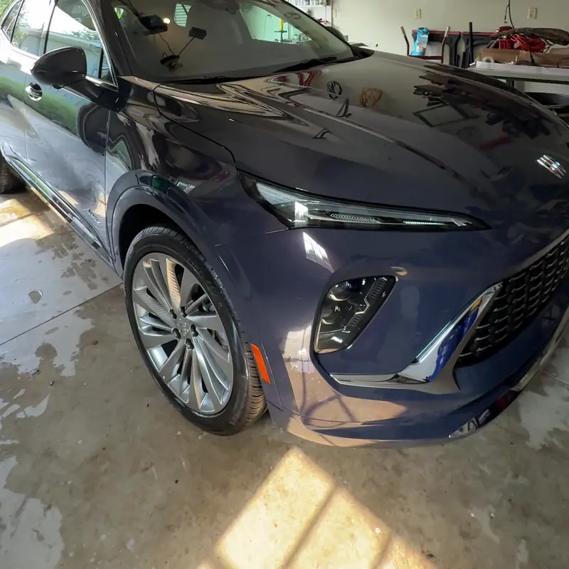 Dark blue-gray Buick Envista in a driveway, three-quarter view after a full detail