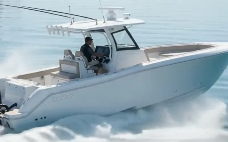 Close view of a glossy white boat hull cutting through the water