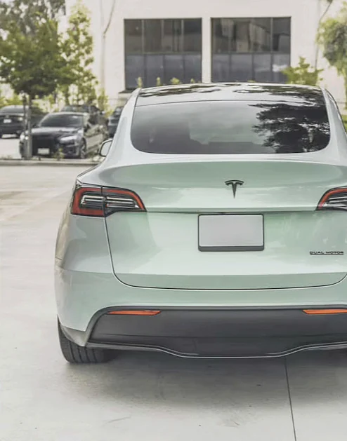 Light green Tesla Model Y seen from behind