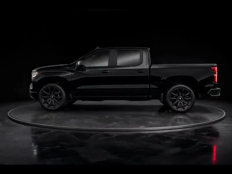Black pickup truck turning on a display platform, shown for the exterior detail package