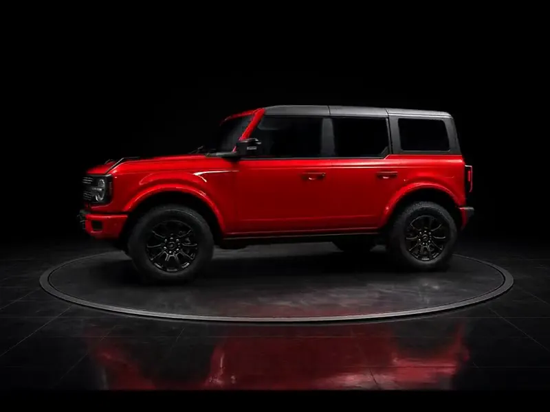 Red SUV turning on a display platform, shown for the interior detail package