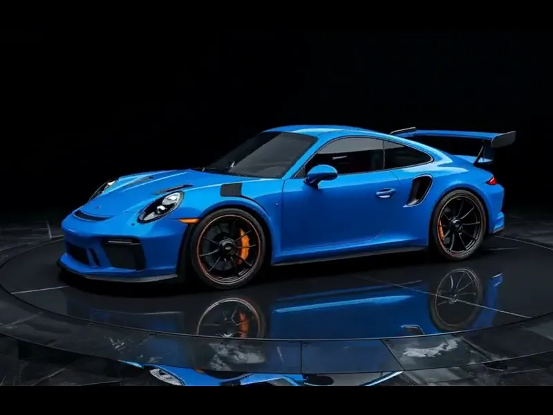 Blue sports car turning on a display platform, shown for paint protection film