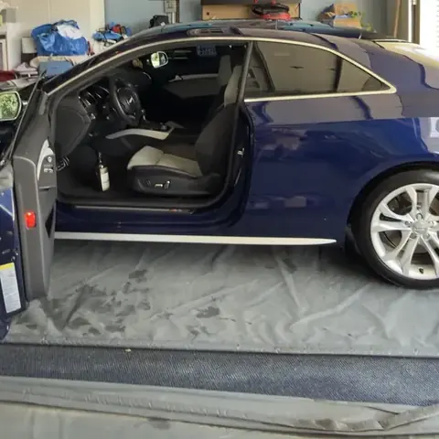 Blue Audi S5 during an interior detail in a garage