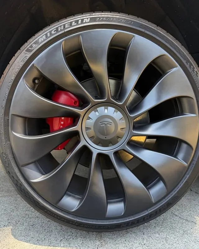 Tesla Model Y wheel after curb rash repair, rim edge restored